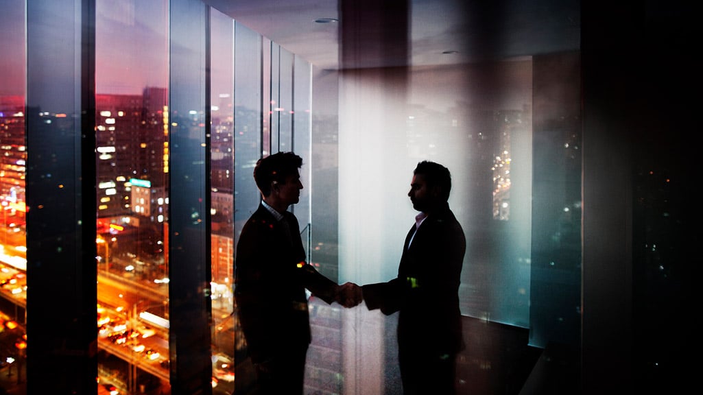 Foreign Corruption FAQs – Men Shaking Hands in Dark Room