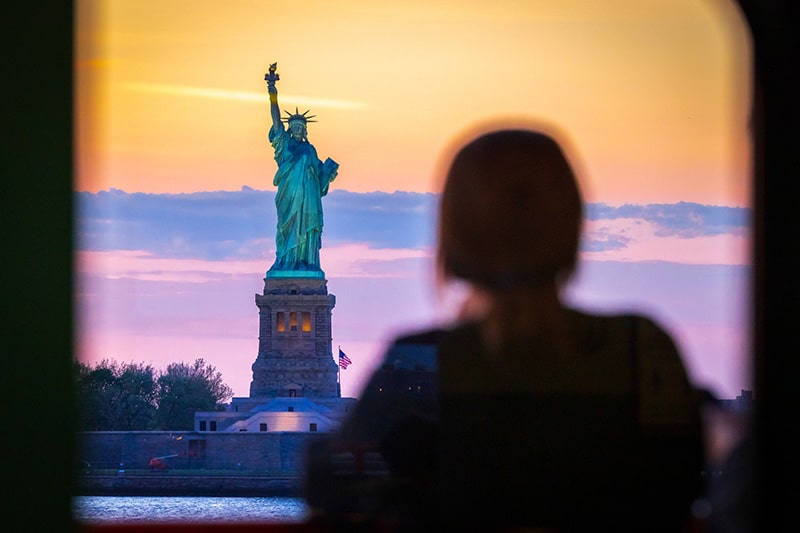 New York Whistleblower Lawyer – Woman Standing in Front of the Statue of Liberty